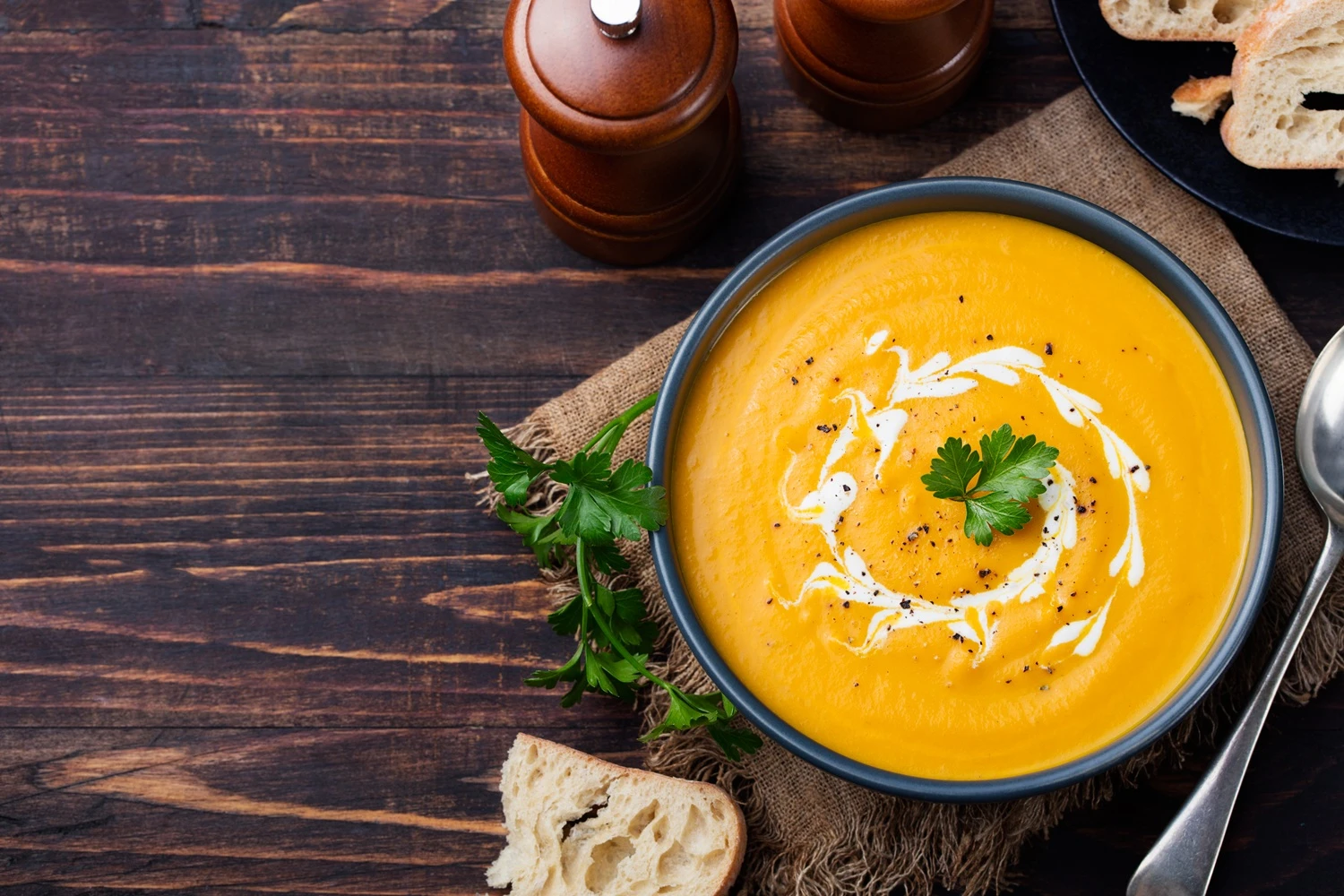 bowl of pumpkin soup on table.